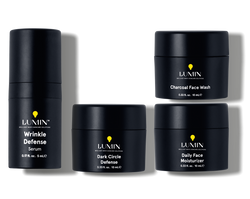 Set of Lumin men's skincare products including Wrinkle Defense Serum, Charcoal Face Wash, Dark Circle Defense, and Daily Face Moisturizer.