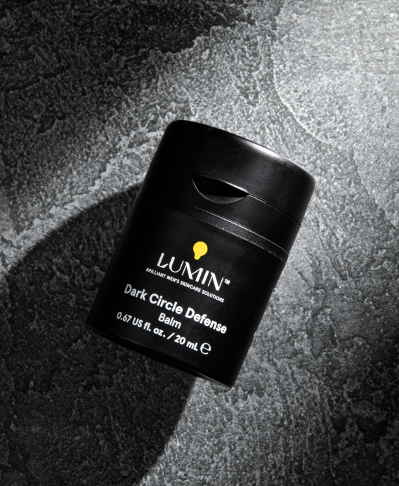Lumin Dark Circle Defense bottle on textured black surface, men's skincare for under-eye dark circles 1.0 fl oz