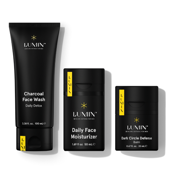 Lumin men's skincare products including charcoal face wash, daily moisturizer, and dark circle defense treatment.