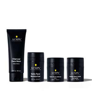 Lumin men's skincare set including charcoal face wash, daily face moisturizer, dark circle defense balm, and instant dark circle corrector.