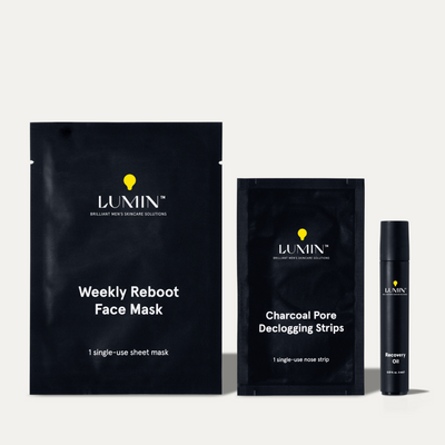 Lumin men's skincare products including Weekly Reboot Face Mask, Charcoal Pore Declogging Strips, and a black serum bottle on white background.