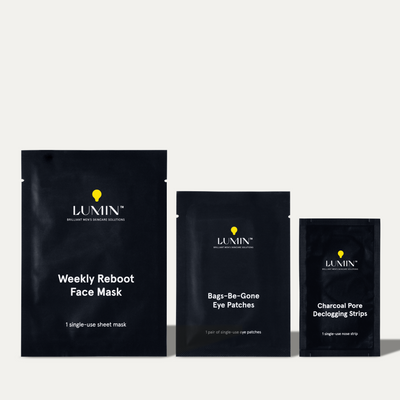 Lumin men's skincare products: Weekly Reboot Face Mask, Bags-Be-Gone Eye Patches, and Charcoal Pore Detoxifying Pads in black packaging.